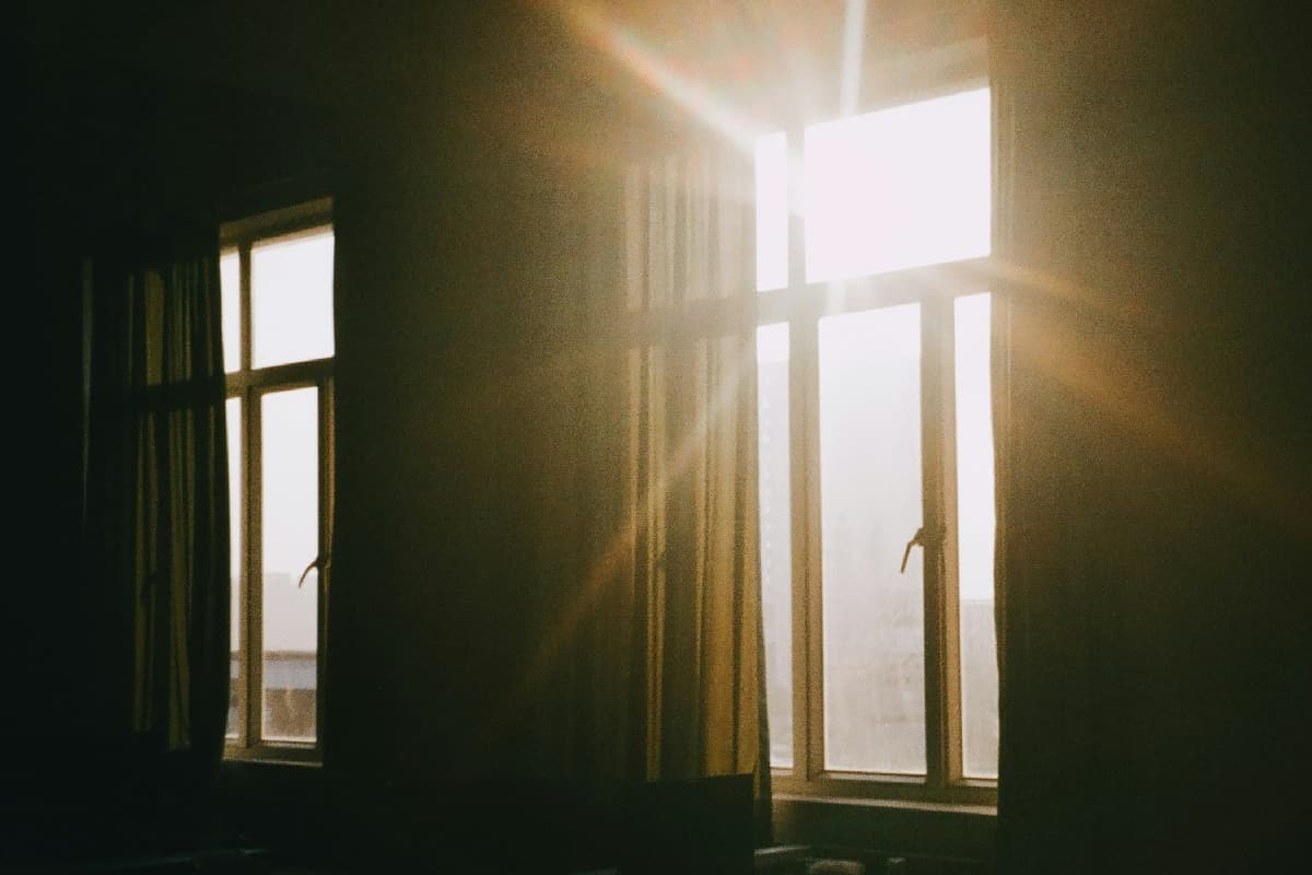 A dark room with a glaring, blown-out window and almost no detail in the walls