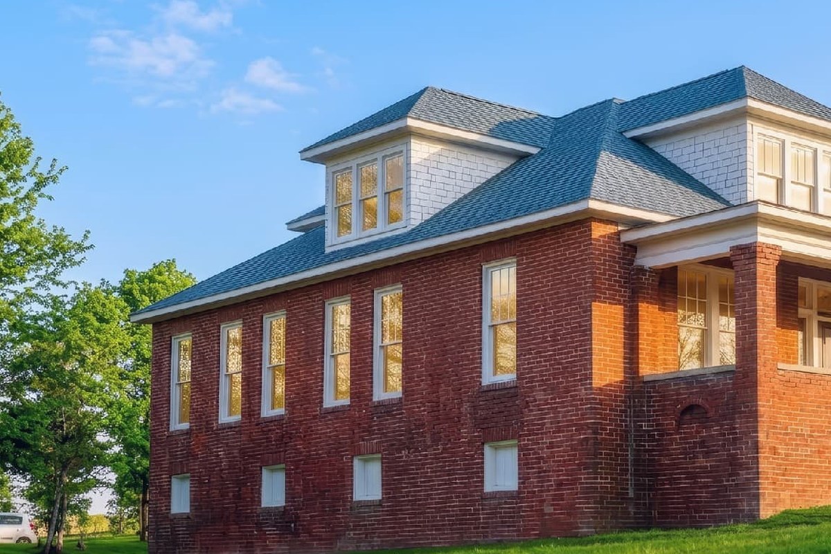 A brick house in daylight under a blue sky
